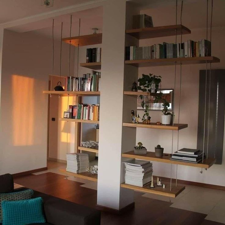 a living room filled with furniture and bookshelves