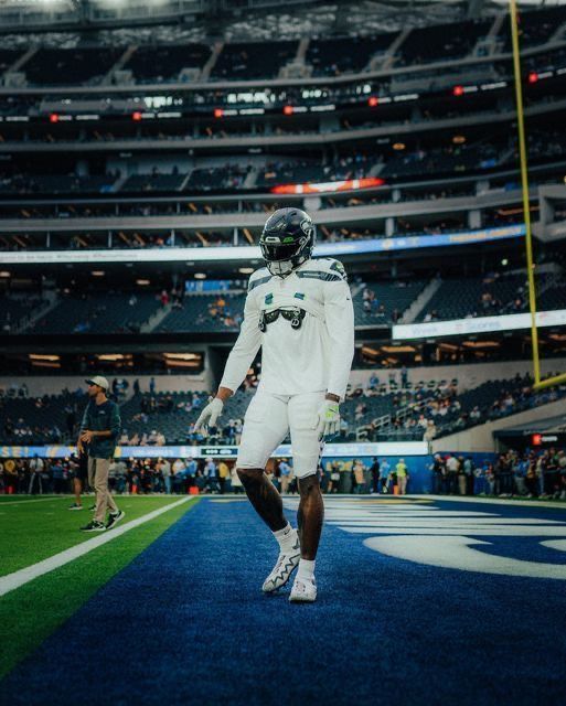 a football player is walking on the field