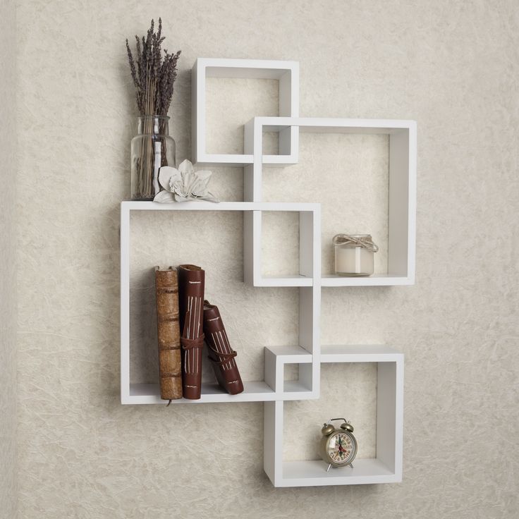 Add a fun and playful flair to your living space with the Danya B. intersecting cube shelves – white. Intersecting cubes create an alluring geometric wall art that doubles as a functional shelf for books, photographs, foliage, and other home décor. The versatile white finish allows easy integration to any color motif. Mount the Danya B. intersecting cube shelves – white in contemporary living rooms or bedrooms to create a fun and modern statement room! Danya B. is a registered trademark of Danya Cube Wall Shelf, White Shelf, Small Shelf, Wooden Wall Shelves, Cube Shelves, Wall Shelves Design, Large Shelves, Floating Wall Shelves, White Laminate