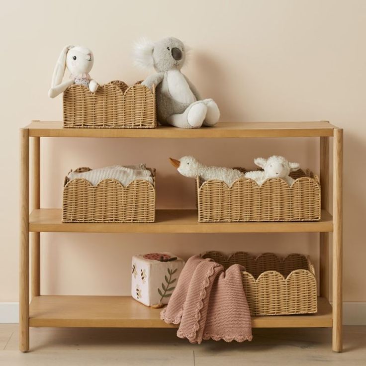 a shelf with baskets and stuffed animals on it