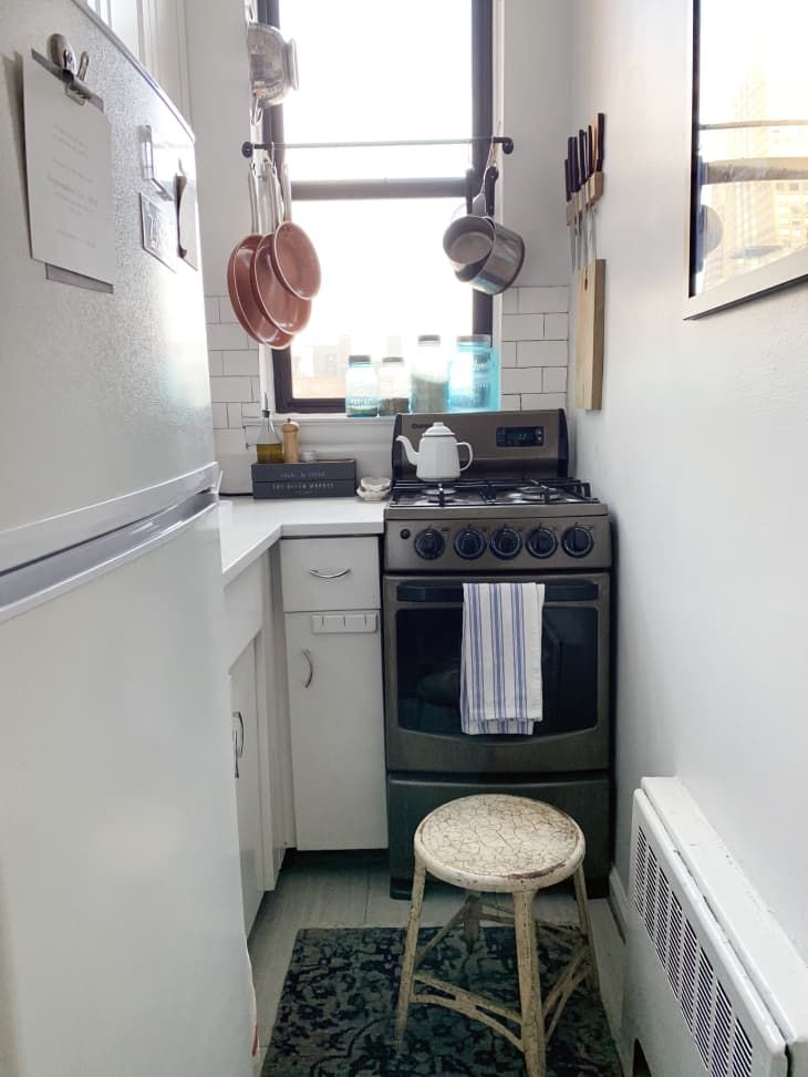 a small kitchen with an oven, stove and refrigerator