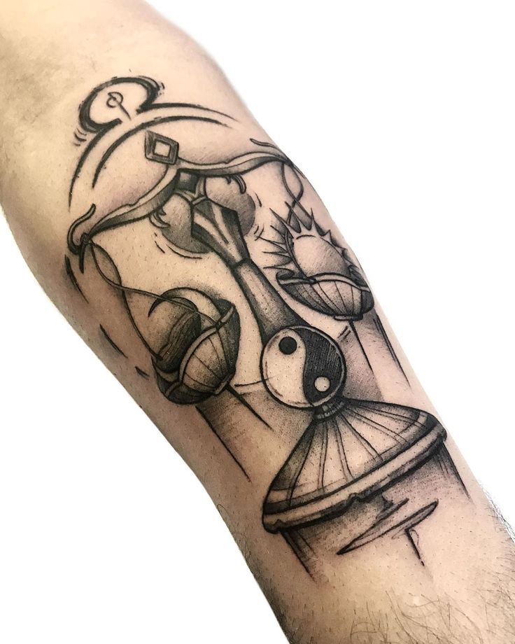 a man's arm with a tattoo on it and an image of a clock