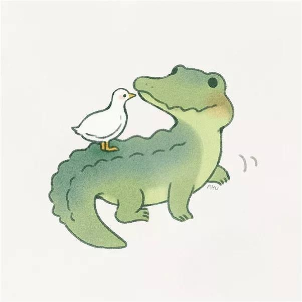 a white bird is standing on the back of a green alligator's head, with its beak in it's mouth