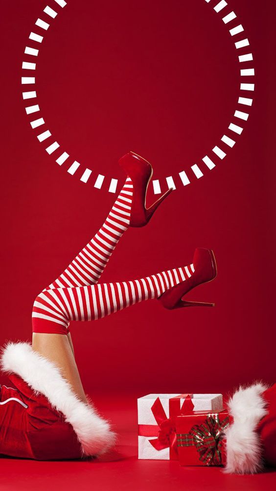 a woman in red and white striped stockings is laying on the floor