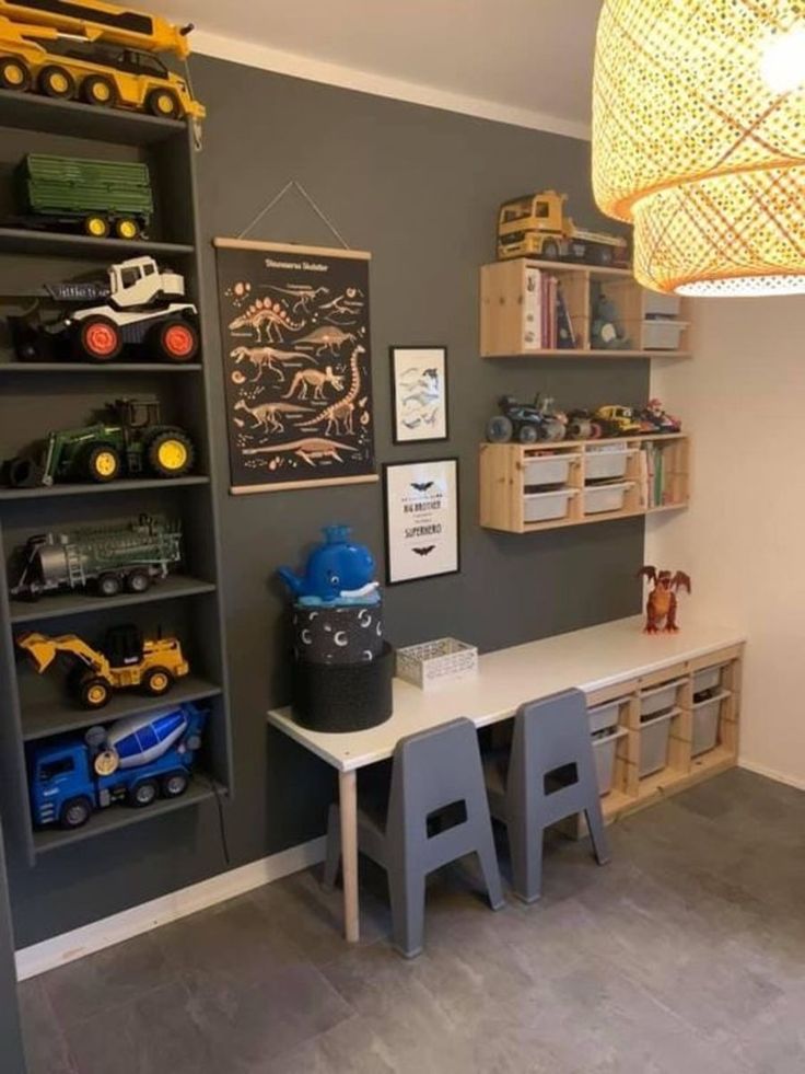 a child's playroom with toy trucks, toys and bookshelves on the wall