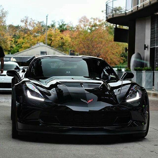 a black sports car is parked on the street