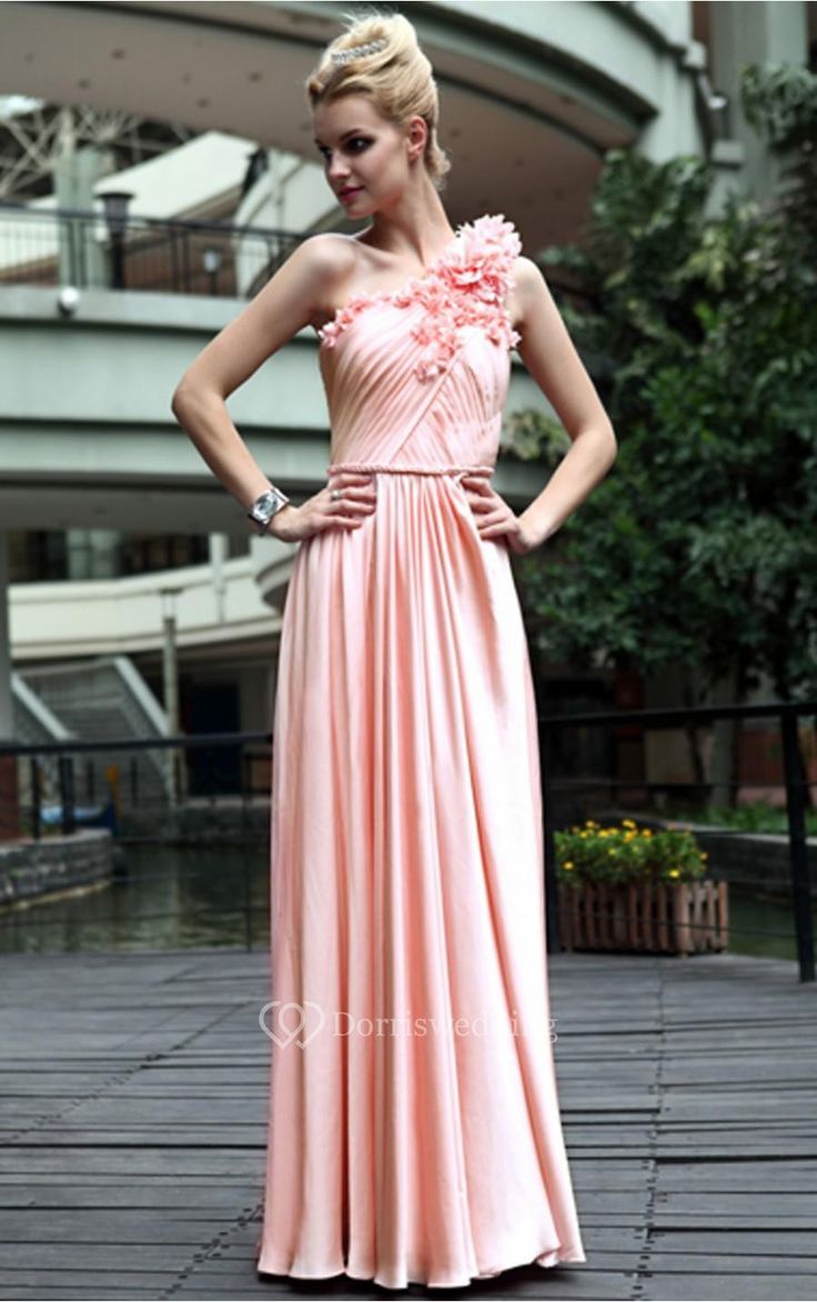 a woman in a long pink dress posing for the camera