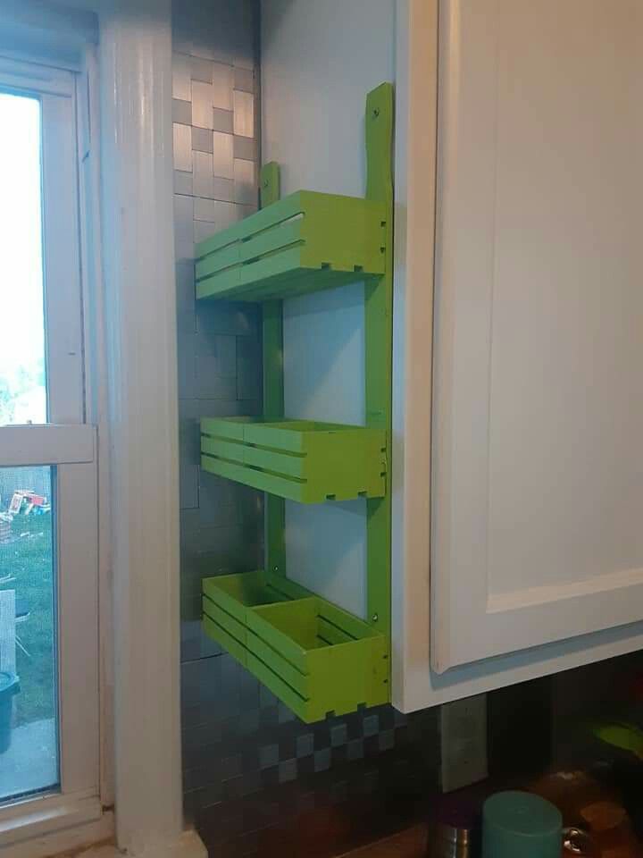 a green shelf sitting in the corner of a kitchen