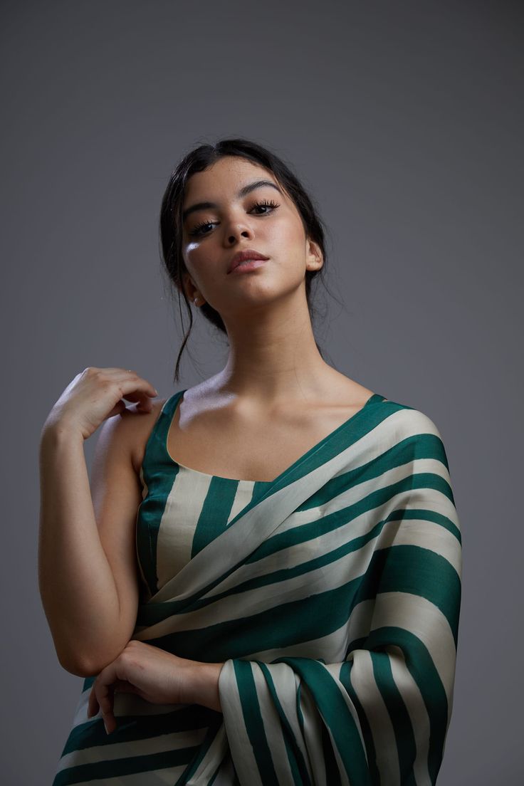 Editor's Note Featuring a green & beige stripe bustier with saree. Color: Green; Beige Fabric: Satin Silk Care: Dry Clean Only About the Designer KoAi means "Love Child" Non-fussy clothes for everyday wear. These pieces can be worn at any time of the day.i.e for work, brunch, evening wear, by the pool. Basically everywhere. Trending Saree, Formal Saree, Simple Saree Designs, Fashionable Saree Blouse Designs, Fancy Sarees Party Wear, Indian Saree Blouses Designs, Indian Fashion Saree, Saree Designs Party Wear, Traditional Indian Outfits