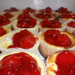 some very tasty looking cupcakes with cherry topping