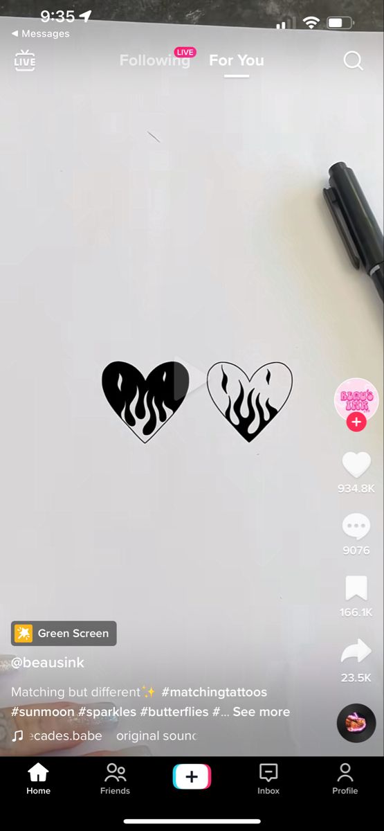 a tablet with two heart stickers on the screen and a pen next to it