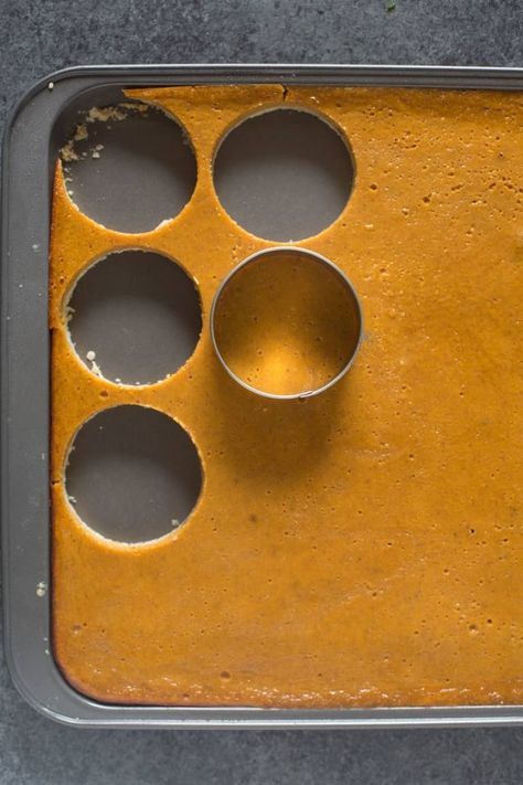 a baking pan filled with muffins on top of a gray counter next to a cupcake tin