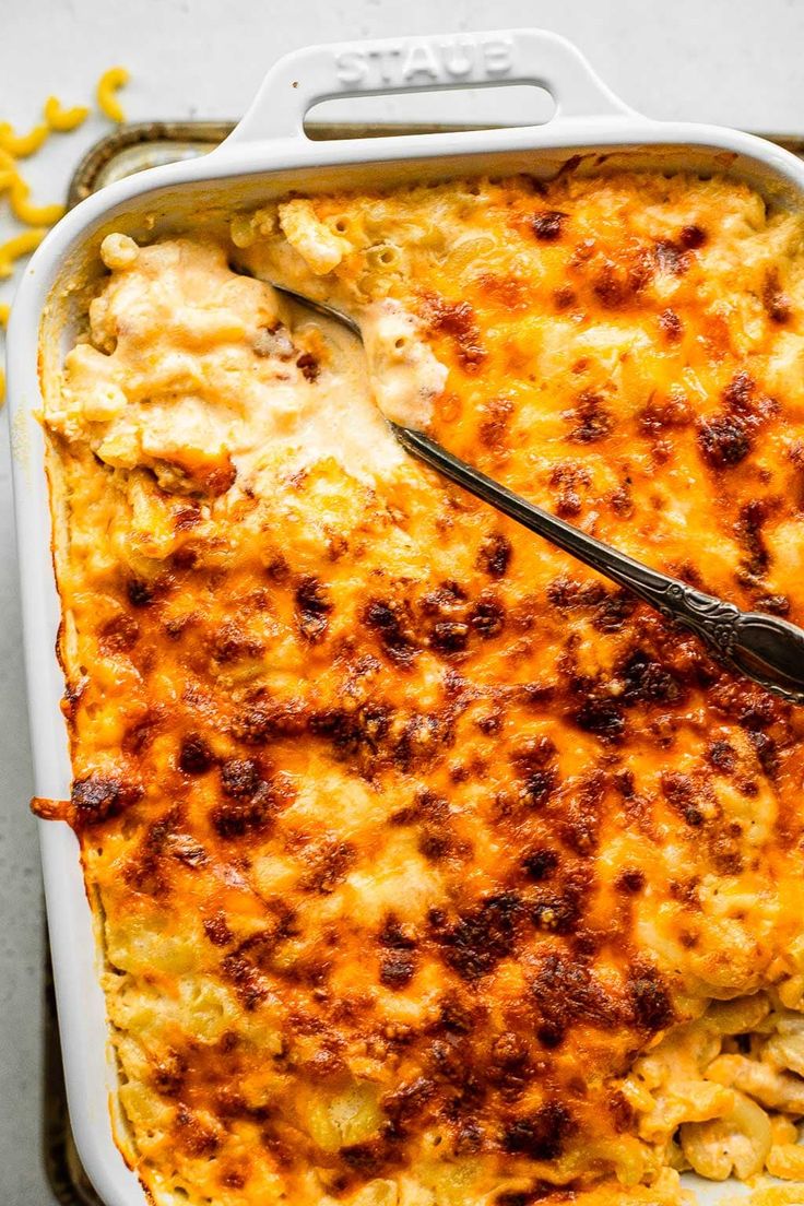 a casserole dish with chicken and cheese in it, ready to be eaten