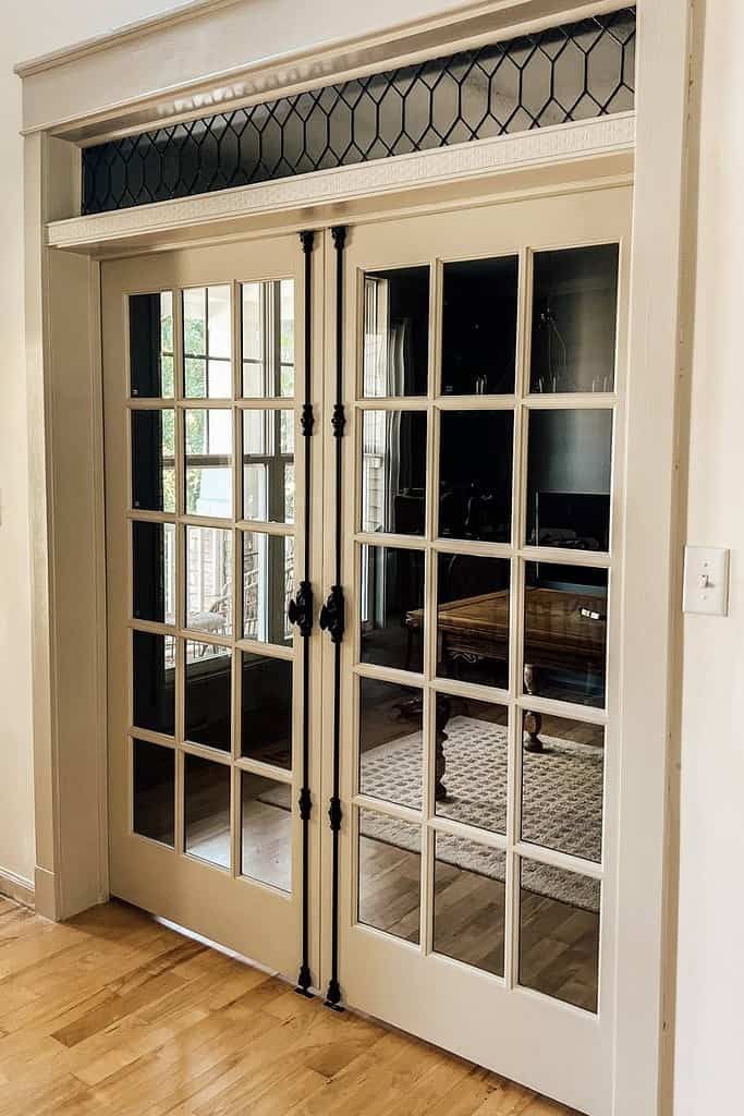 an empty room with glass doors and hard wood flooring in front of the door