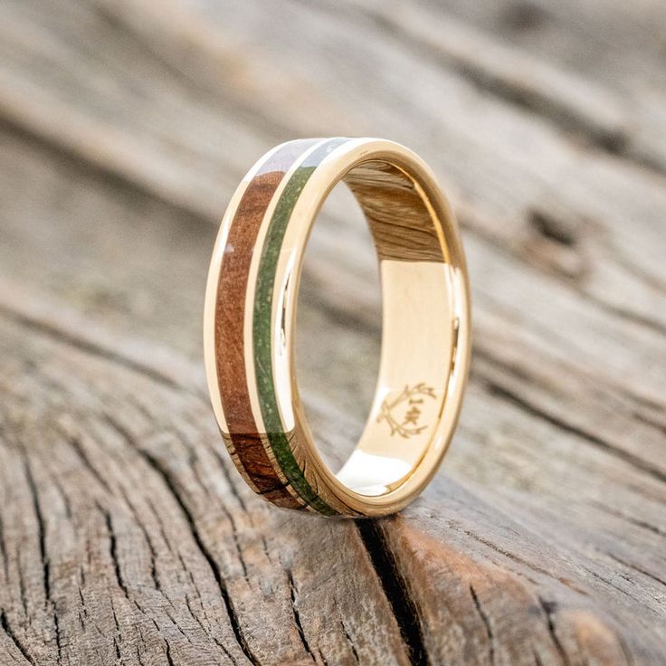 a wooden ring with two different colored wood inlays