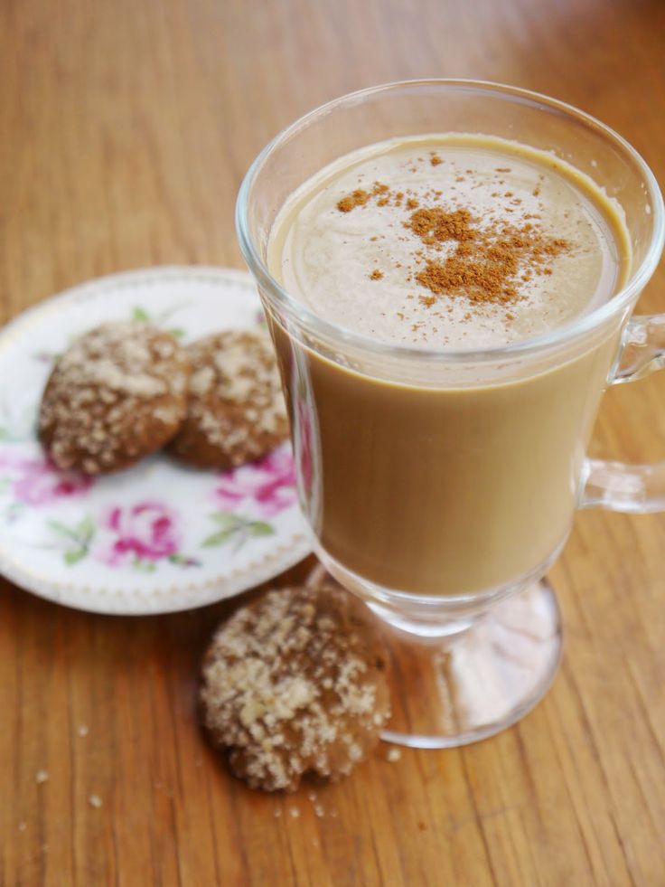 a cup of coffee and some cookies on a table