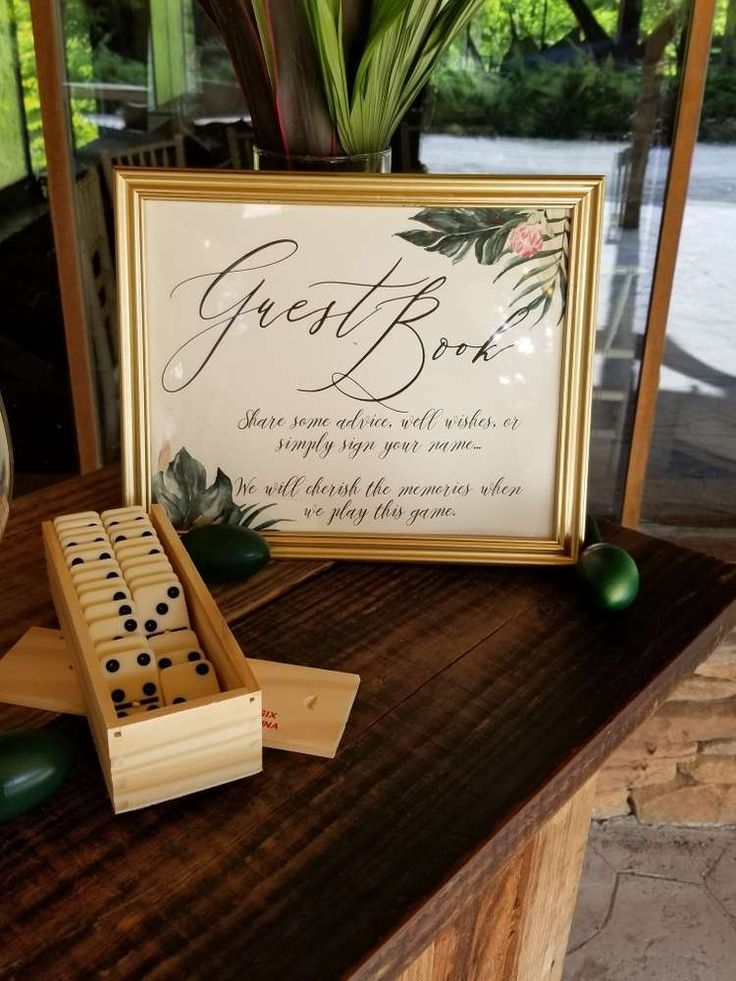 a wooden board game sitting on top of a table next to a vase filled with flowers