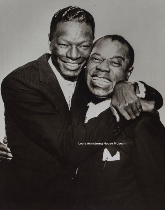 two men are hugging each other in black and white