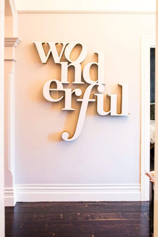 a white wall with the words wow and fru on it in cursive letters