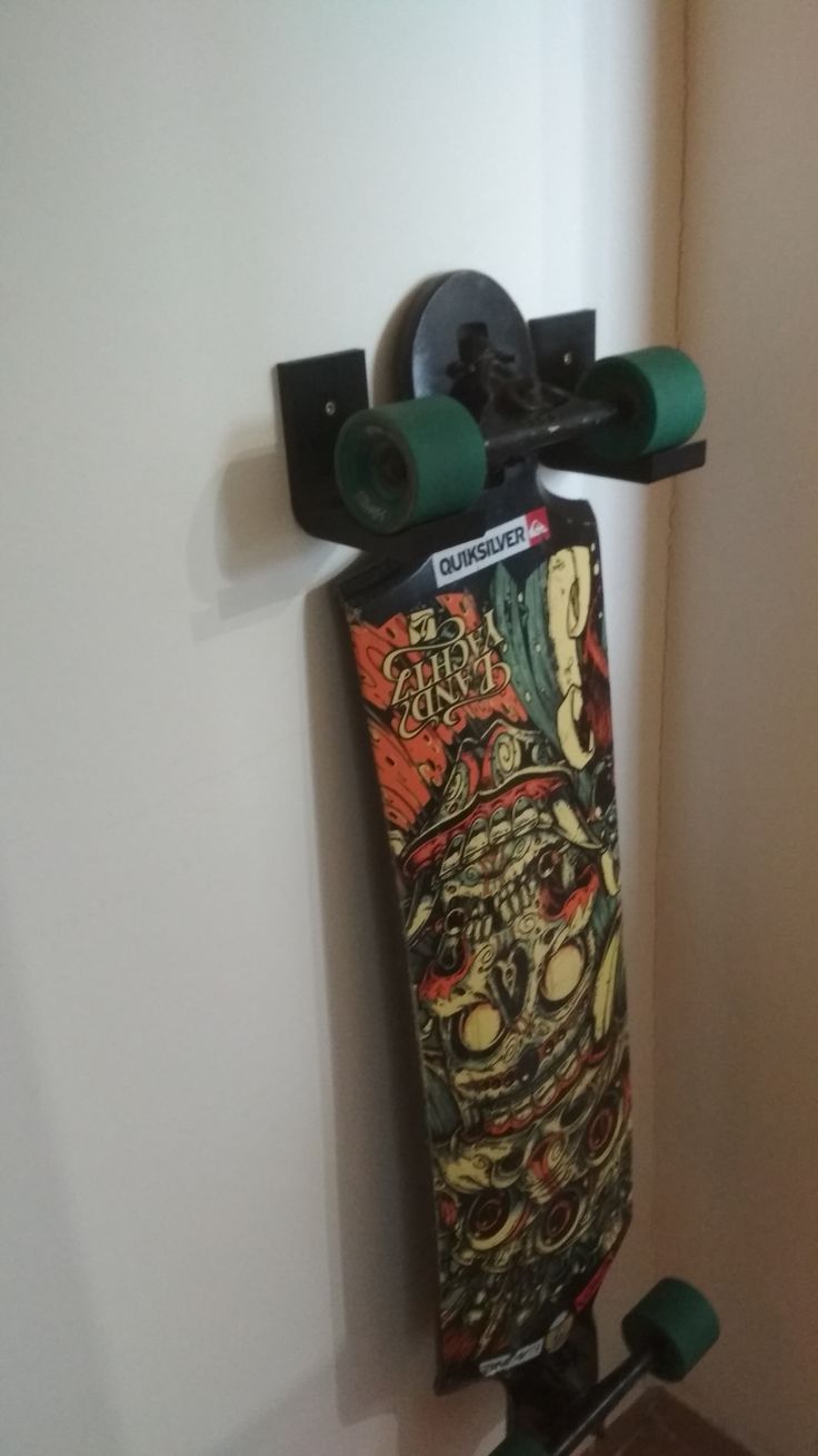 a skateboard mounted to the side of a wall with wheels on it's sides