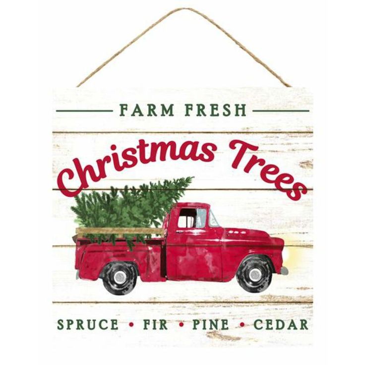 a red truck with a christmas tree in the bed is hanging on a white wooden sign