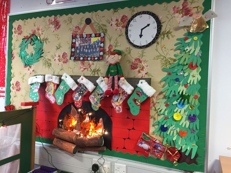 a christmas fireplace with stockings and stockings hanging from it's mantle next to a clock