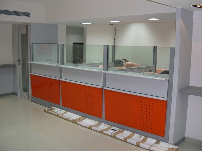 an empty room with orange and grey cabinets