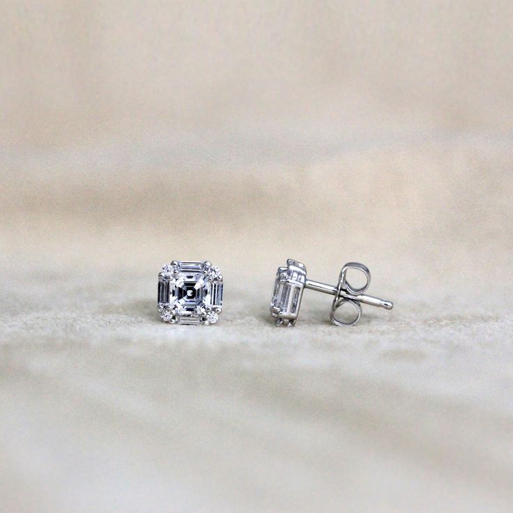 Metal: 925 Sterling Silver Stone Cut: Asscher Cut, Brilliant Cut, Baguette Cut Earring Dimension: 7.0mm (L) x 7.0mm (W) Setting Type & Style: Post, Stud, Prong Total Stone Weight: 1.18 cttw Silver Emerald Cut Diamond Earrings With Baguettes, Silver Emerald-cut Baguette Diamond Earrings, Asscher Cut White Gold Diamond Earrings, Sterling Silver Baguette Cut Diamond Earrings, Sterling Silver Earrings With Baguette Cut And Prong Setting, White Gold Sterling Silver Baguette Cut Earrings, Asscher Cut Diamond Earrings With Prong Setting, Asscher Cut Prong Set Diamond Earrings, Dazzling Sterling Silver Baguette Cut Earrings