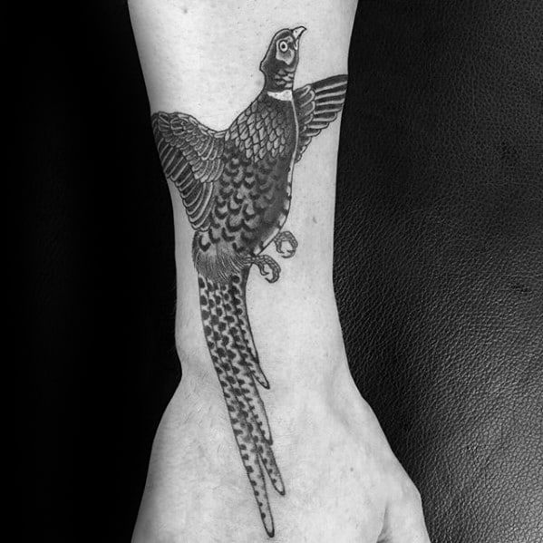 a black and white photo of a bird on the wrist