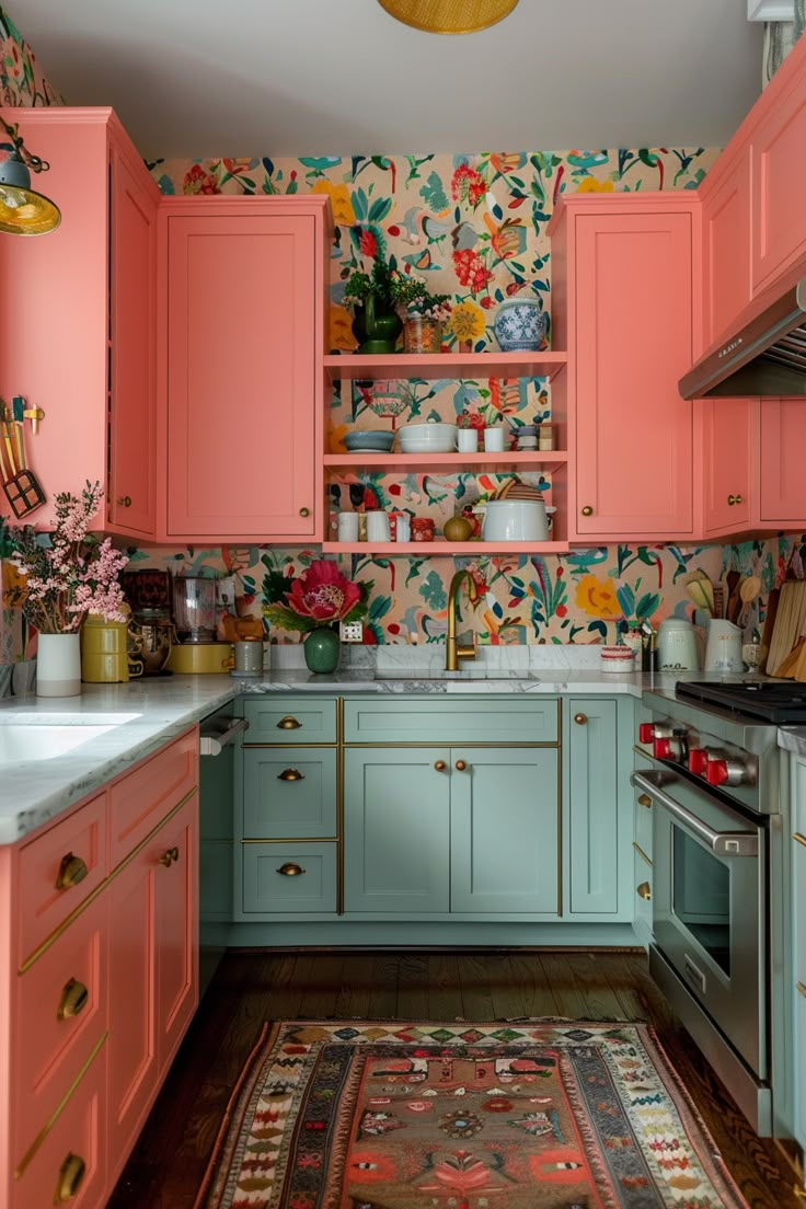 a kitchen with pink cabinets and floral wallpaper on the walls, along with a rug