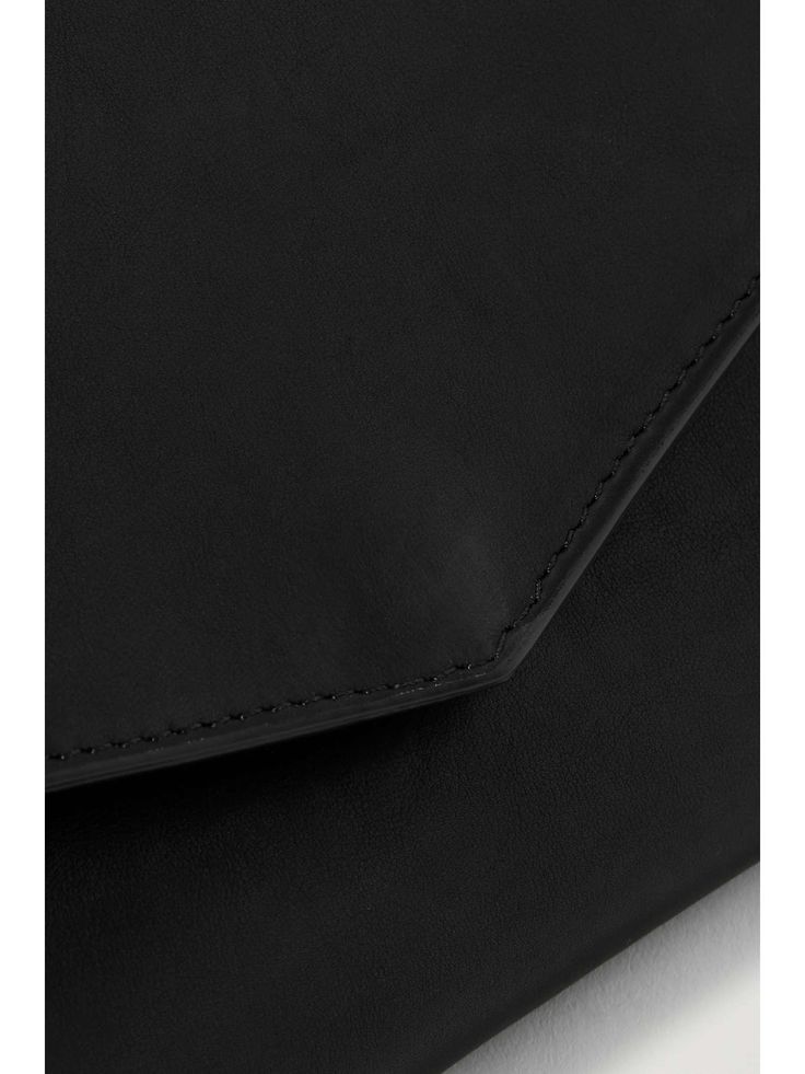 THE ROW Envelope leather shoulder bag | NET-A-PORTER Minimalist Leather Rectangular Clutch, Minimalist Rectangular Leather Clutch, Modern Leather Clutch For Work, Black Leather Minimalist Clutch, Minimalist Black Leather Clutch, Modern Soft Leather Clutch For Office, Sleek Leather Rectangular Clutch, Sleek Leather Clutch For Business, Modern Soft Leather Office Clutch