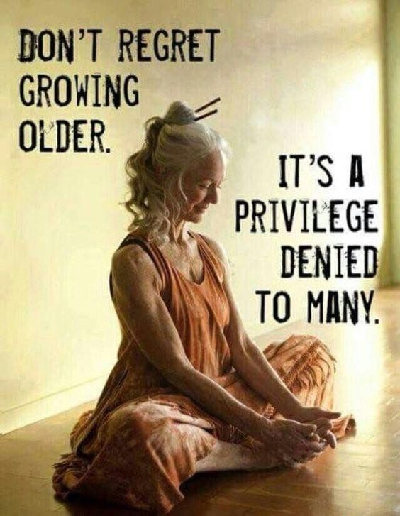 an old woman sitting on the floor with her hands in her pockets and saying don't reget growing older it's a priv