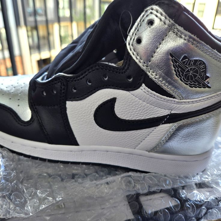 Metallic Blk And Whit Og Jordan 1 High-Top. Silver Lace-up Sneakers With Metallic Logo, Silver Sneakers With Metallic Logo For Streetwear, Silver Custom Sneakers For Streetwear, Silver Custom Sneakers With Boost Midsole, Silver Custom Sneakers With Boost Midsole For Sports, Sporty Silver High-top Custom Sneakers, Silver High-top Sneakers With Boost Midsole, Silver Leather Low-top Custom Sneakers, Silver Custom Sneakers With Boost Midsole For Streetwear