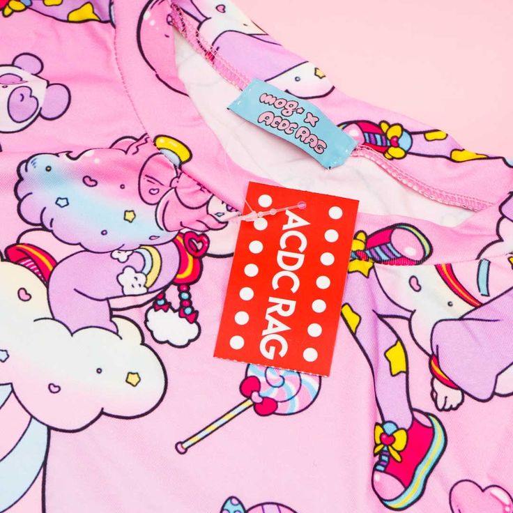 Brighten up your mood by wearing this super cute tee with a print of a pastel pop animé girt called “Fuwa-chan!” This Harajuku-inspired brand gets its fashion aesthetic from the colorful streets of Takeshita! The design itself is a collab with a Japanese animator named “mog.” A kawaii t-shirt decorated with a pastel illustration of Fuwa-chan Features a collaboration with Japanese animator named mog Made of soft polyester material Length: approx. 70 cm / 27.56 inches Shoulder width: approx. 52 cm Pastel Goth Cotton T-shirt With Graphic Print, Pink Funny Print Kawaii Tops, Pink Kawaii Top With Funny Print, Playful Pink T-shirt With Graphic Print, Playful Pink Graphic Print T-shirt, Pink Harajuku Style T-shirt With Letter Print, Kawaii Pink Summer T-shirt, Pink Kawaii T-shirt For Summer, Pink Harajuku Style Graphic T-shirt