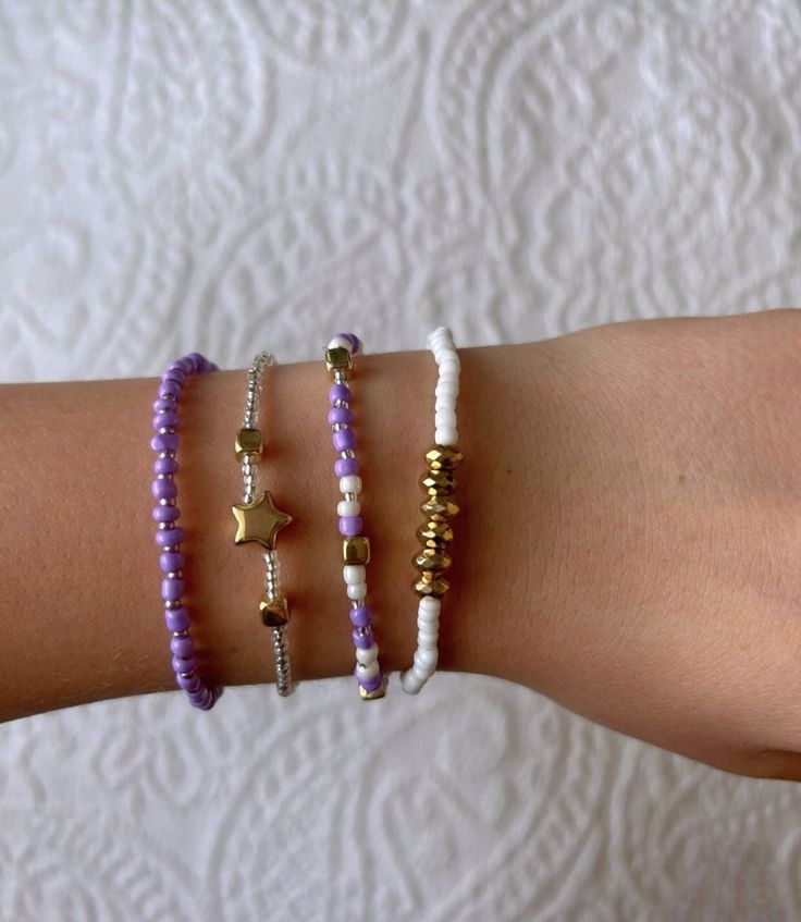 This pretty purple bracelet set is super cute and has a mix between purple and white with some gold accents. It is homemade and great quality! Trendy Purple Friendship Bracelets, Trendy Purple Jewelry For Everyday, Trendy Purple Everyday Jewelry, Trendy Everyday Purple Jewelry, Trendy Purple Beaded Bracelets, Trendy Purple Beaded Bracelets For Everyday, Everyday Purple Beaded Bracelets, Trendy Everyday Purple Beaded Bracelets, Everyday Purple Jewelry With Letter Beads