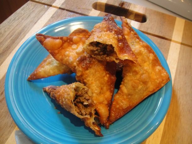 some food is on a blue plate on a wooden table