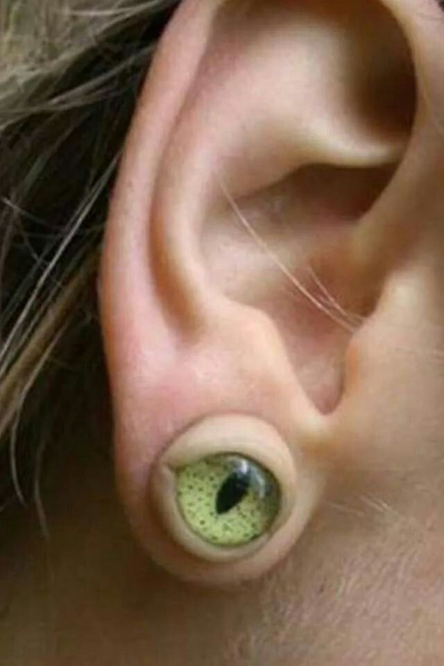 an ear with two green eyes on it