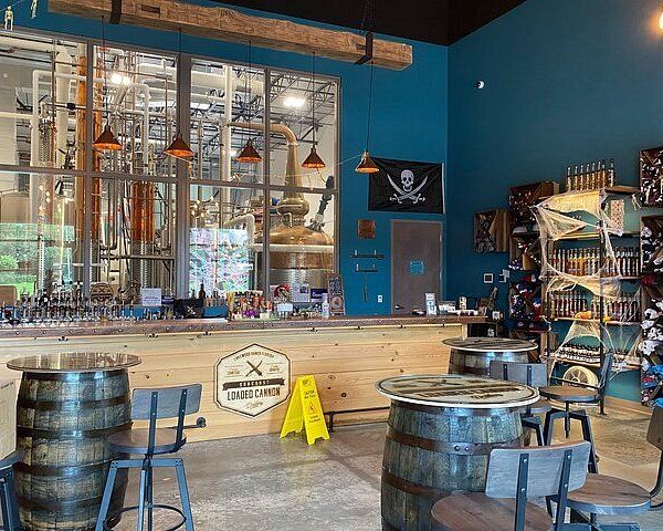 the inside of a bar with several wooden barrels