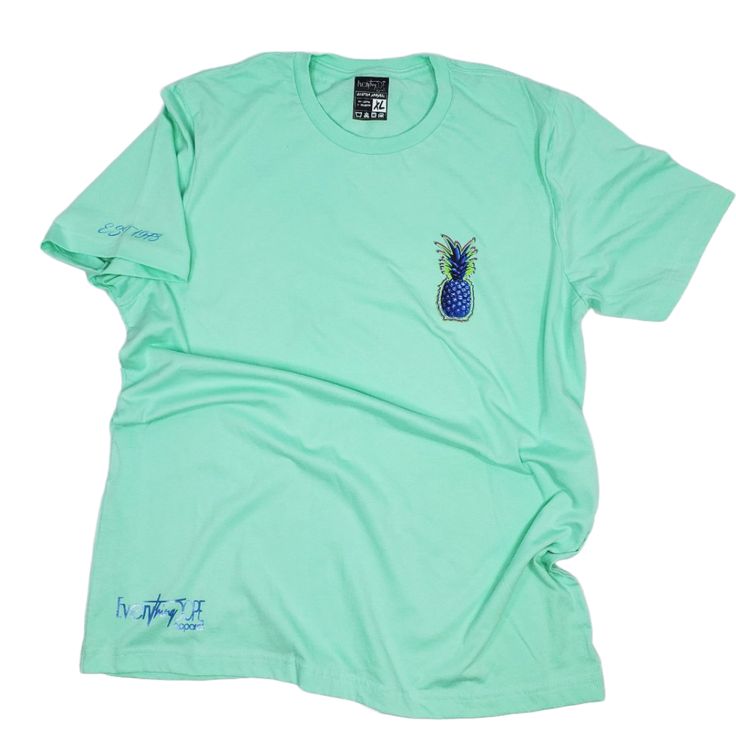 Elevate your summer wardrobe with our Limited Edition Mint Green Short Sleeve Crewneck T-Shirt featuring a vibrant full-color blue pineapples graphic. Crafted from 99% pure cotton, this t-shirt combines style and comfort effortlessly. Ideal for any casual occasion, this machine-washable t-shirt is a standout piece in any collection. Key Features: Material: Made from 99% pure cotton, ensuring a soft and breathable feel. Color: Refreshing mint green, perfect for summer. Design: Eye-catching full-c Relaxed Fit T-shirt With Back Print For Summer, Casual Short Sleeve Shirt With Back Print, Summer Cotton Shirt With Back Print, Cotton Shirt With Back Print For Summer, Summer Cotton Tops With Back Print, Casual Summer Shirt With Back Print, Cotton Tops With Back Print For Summer, Summer Graphic Tee With Back Print, Summer Streetwear Tops With Back Print