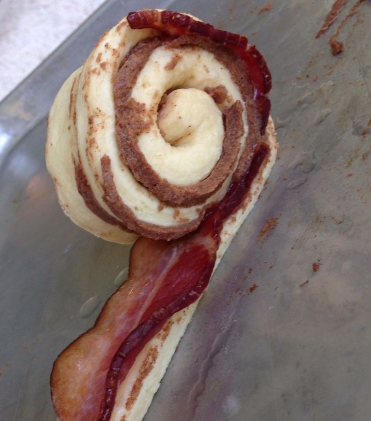 a bacon and cheese roll sitting on top of a pan