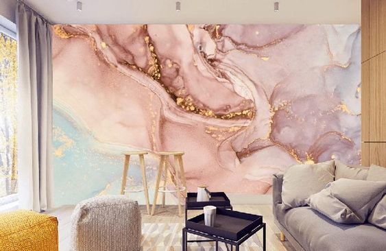 a living room filled with furniture and walls covered in pink, gold and white marble