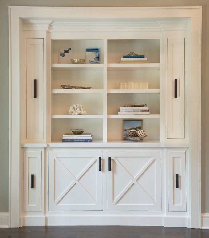 a white bookcase with doors and drawers