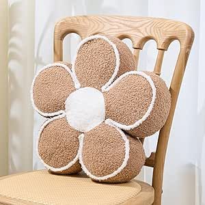 a stuffed flower on top of a wooden chair