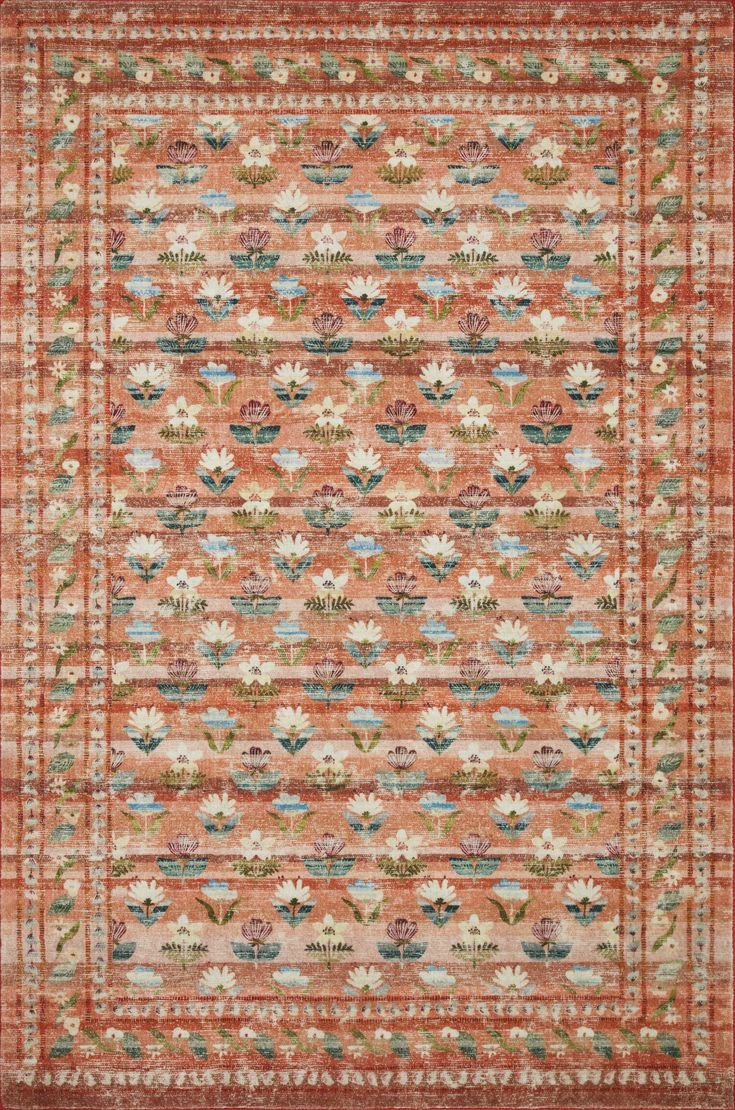 an orange and blue rug with flowers on it