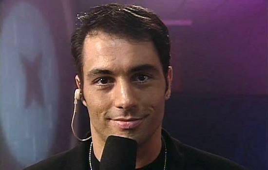 a close up of a person with a microphone in front of him and a purple background