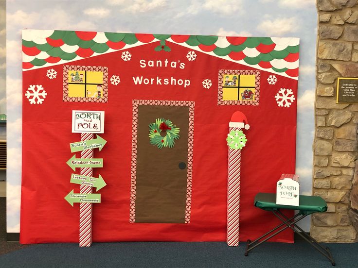 a red building with christmas decorations on the front and side walls, decorated for santa's workshop