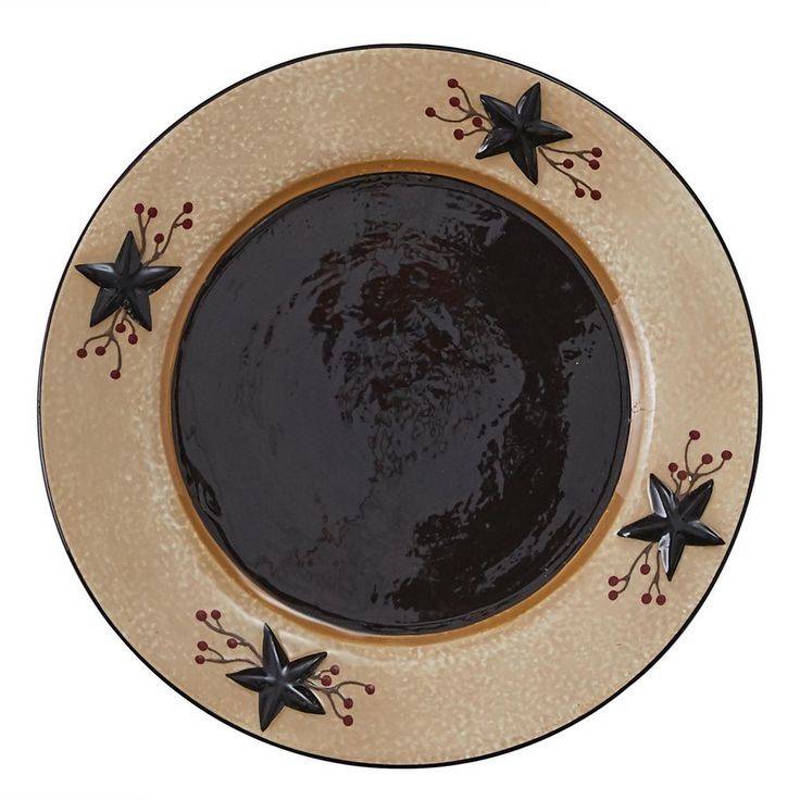 a black and tan plate with stars on the rim is sitting in front of a white background