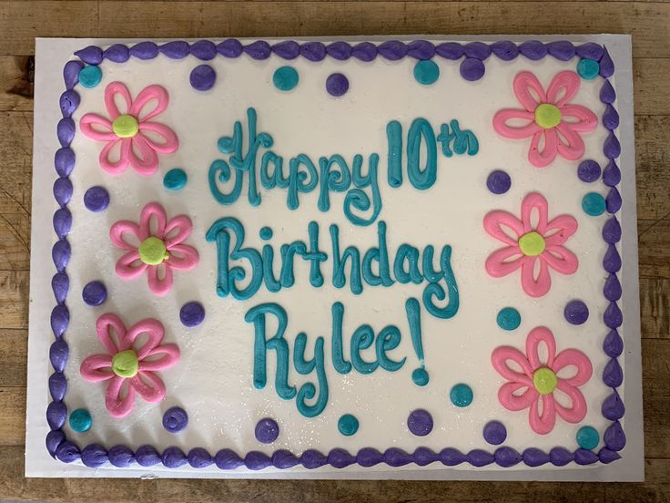 the birthday cake is decorated with flowers and polka dots