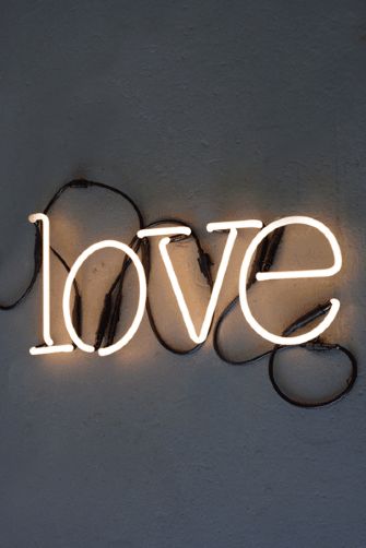 the word love is lit up in white letters