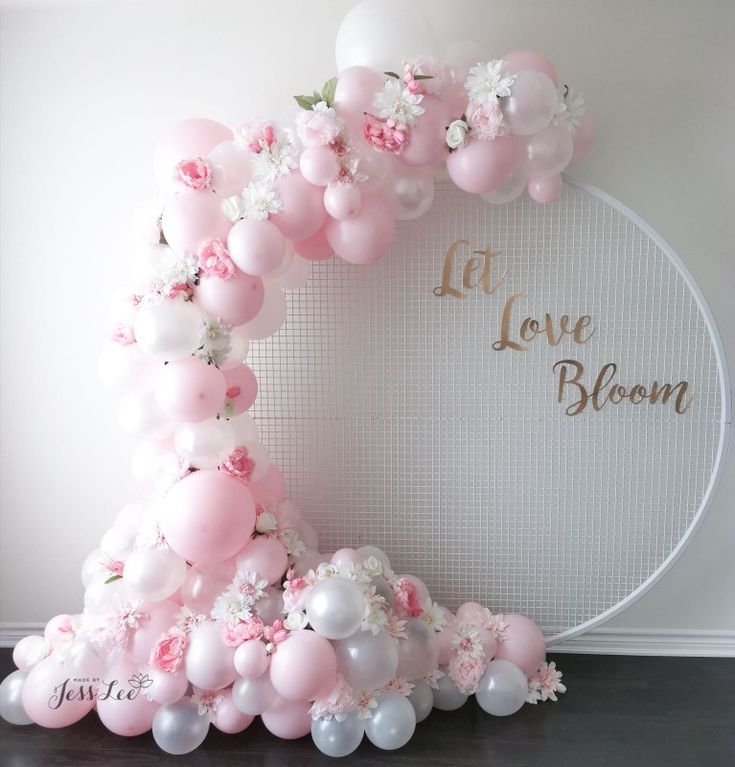 a balloon arch with pink and white balloons